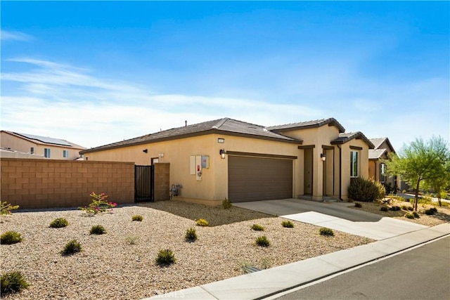 11624 Sky Pointe Dr, Desert Hot Springs, CA 92240 - ranch-style home with an attached garage, concrete driveway, stucco siding, and a gate