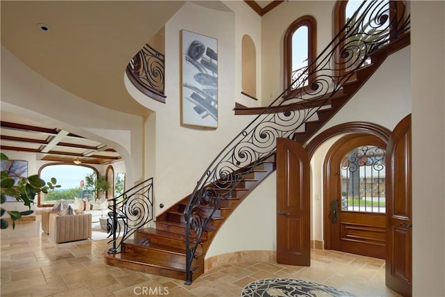 3300 Ocean Blvd, Corona Del Mar, CA 92625 - foyer entrance featuring stone tile floors, plenty of natural light, stairs, beam ceiling, and a high ceiling