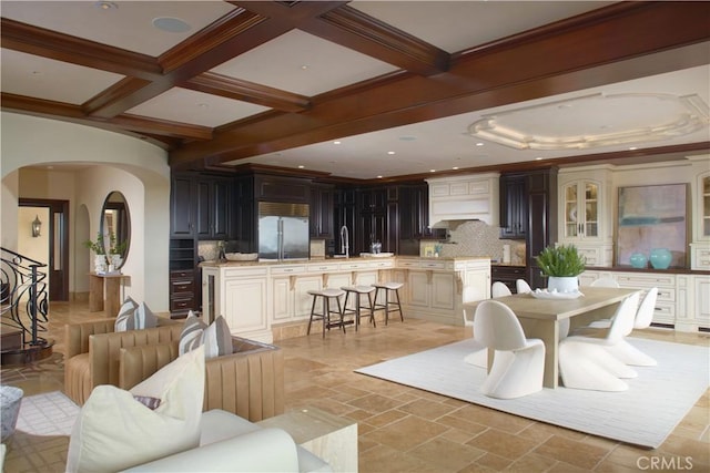 3300 Ocean Blvd, Corona Del Mar, CA 92625 - living room featuring arched walkways, beam ceiling, stone tile floors, coffered ceiling, and recessed lighting
