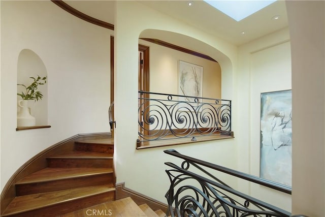 3300 Ocean Blvd, Corona Del Mar, CA 92625 - staircase with arched walkways, a skylight, wood finished floors, and recessed lighting