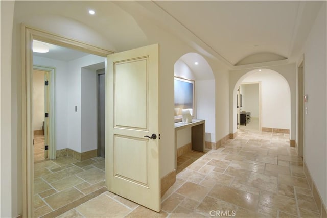 3300 Ocean Blvd, Corona Del Mar, CA 92625 - corridor featuring stone tile flooring, lofted ceiling, recessed lighting, and arched walkways