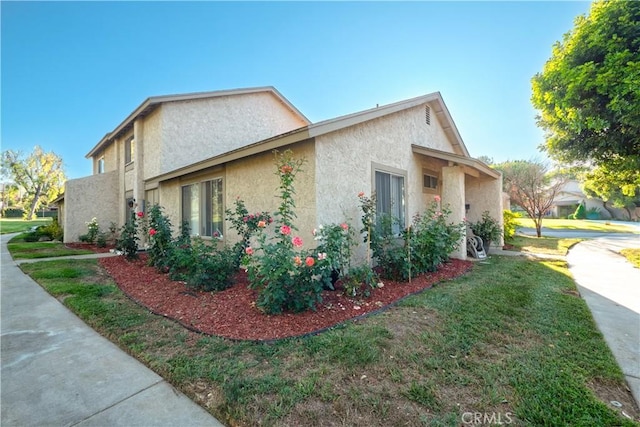 624 Pamela Kay Ln, La Puente, CA 91746 - view of side of property featuring stucco siding and a lawn