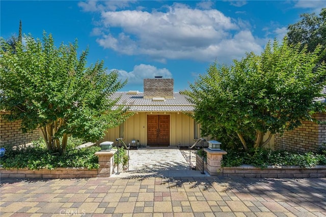 4308 Crown Ranch Rd, Corona, CA 92881 - view of front of property with board and batten siding, french doors, and a chimney