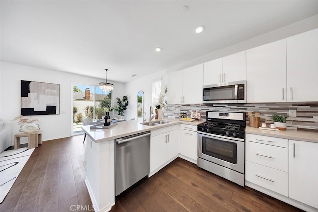13450 Prosperity Pl, Garden Grove, CA 92843 - kitchen with stainless steel appliances, a peninsula, light countertops, dark wood-type flooring, and recessed lighting