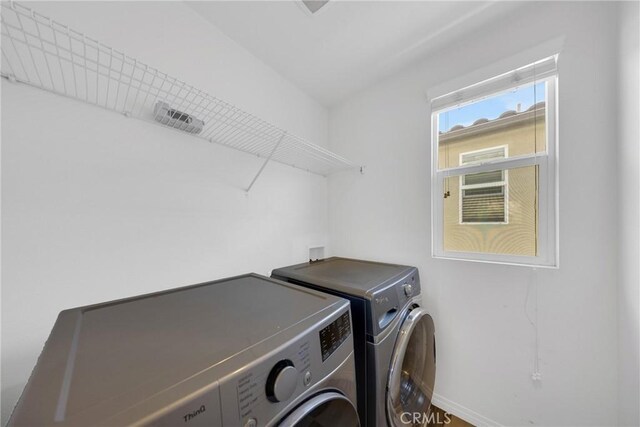 13450 Prosperity Pl, Garden Grove, CA 92843 - laundry area with washing machine and dryer and baseboards