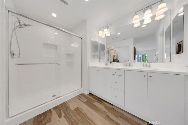 13450 Prosperity Pl, Garden Grove, CA 92843 - full bathroom featuring a shower stall, double vanity, recessed lighting, and wood finished floors