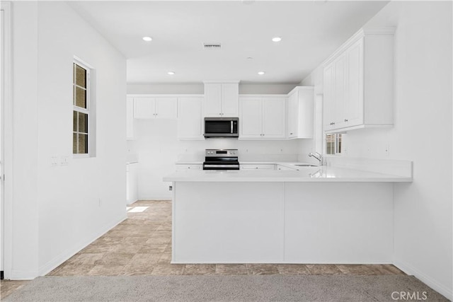 16173 Alamo Ct, Chino, CA 91708 - kitchen with appliances with stainless steel finishes, light countertops, white cabinets, a peninsula, and recessed lighting