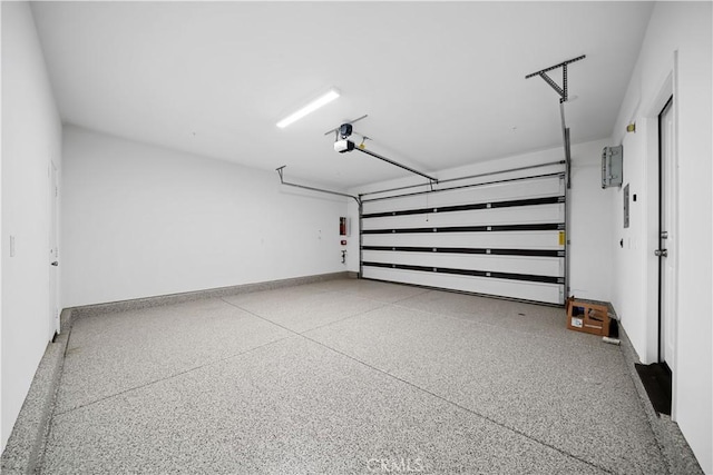 16173 Alamo Ct, Chino, CA 91708 - garage featuring a garage door opener and baseboards