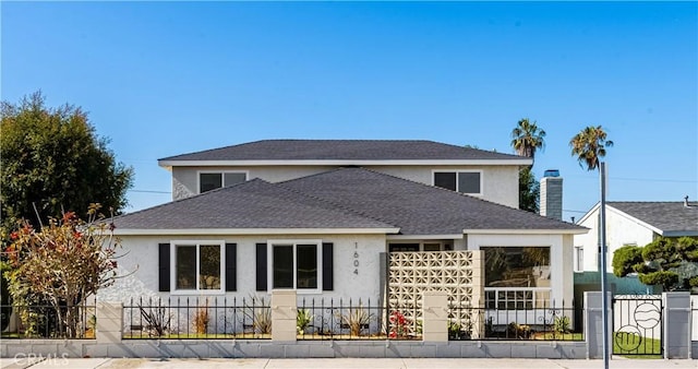 1604 W 125th St, Los Angeles, CA 90047 - view of front of house with stucco siding, a fenced front yard, and a shingled roof