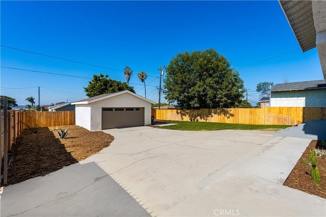 1604 W 125th St, Los Angeles, CA 90047 - view of front of property with a garage, an outdoor structure, a fenced backyard, and stucco siding