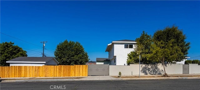 1604 W 125th St, Los Angeles, CA 90047 - view of home's exterior featuring a fenced front yard and stucco siding