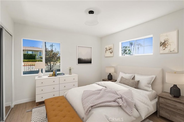 1604 W 125th St, Los Angeles, CA 90047 - bedroom with light wood finished floors and baseboards