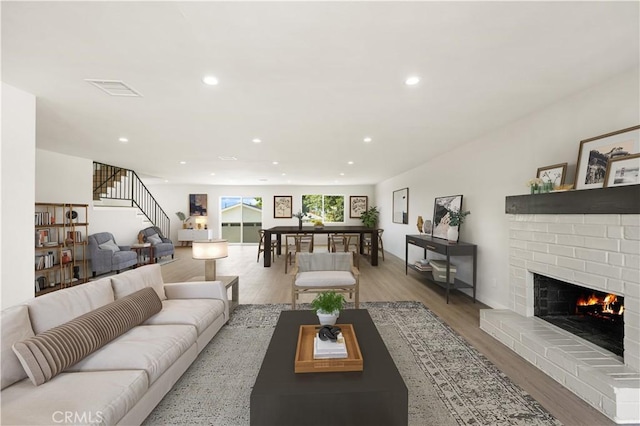 1604 W 125th St, Los Angeles, CA 90047 - living area featuring recessed lighting, stairs, wood finished floors, and a brick fireplace