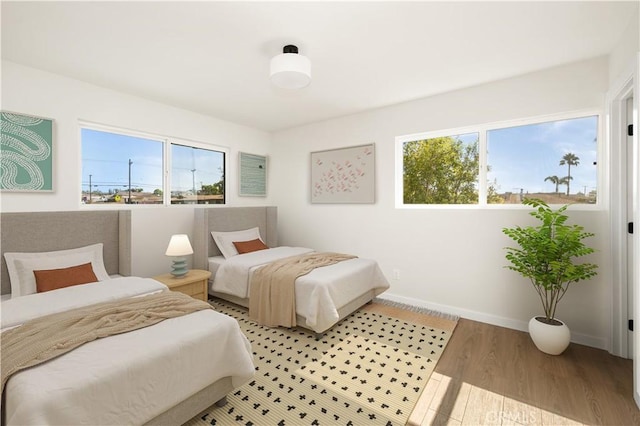1604 W 125th St, Los Angeles, CA 90047 - bedroom featuring multiple windows and wood finished floors