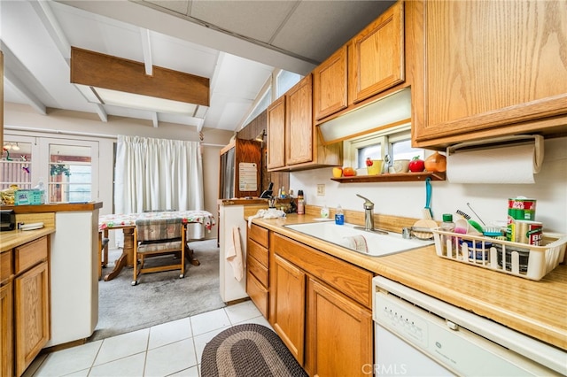 618 E 2nd St, Rialto, CA 92376 - kitchen with dishwasher, light carpet, light tile patterned floors, light countertops, and brown cabinetry