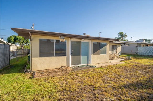 618 E 2nd St, Rialto, CA 92376 - back of house with stucco siding and a patio area