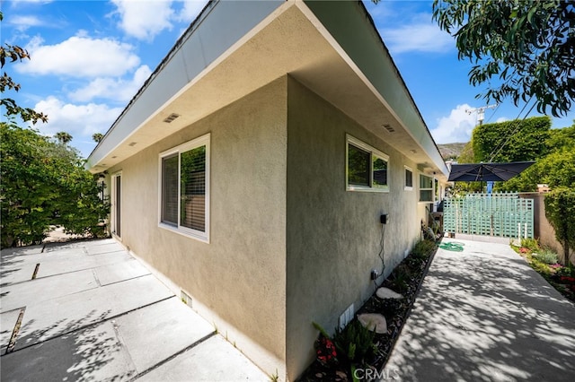 1575 Via Capri Unit 6, Laguna Beach, CA 92651 - view of side of property featuring a patio area and stucco siding