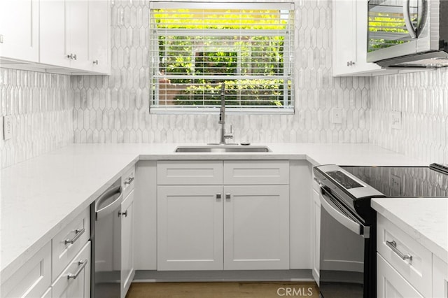1575 Via Capri Unit 6, Laguna Beach, CA 92651 - kitchen featuring black / electric stove, tasteful backsplash, light countertops, white cabinets, and stainless steel dishwasher