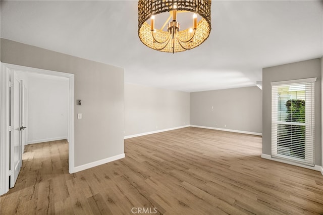 1575 Via Capri Unit 6, Laguna Beach, CA 92651 - unfurnished living room with light wood-type flooring and a chandelier