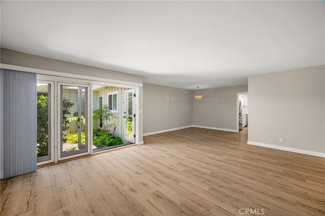 1575 Via Capri Unit 6, Laguna Beach, CA 92651 - spare room featuring wood finished floors and a chandelier