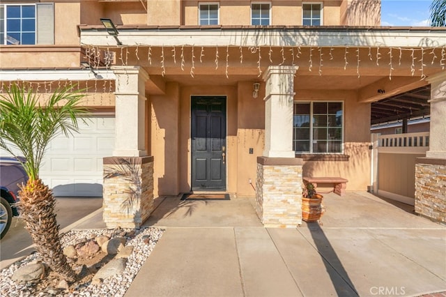 7459 Melanie Ct, Highland, CA 92346 - property entrance featuring stucco siding, a porch, and stone siding
