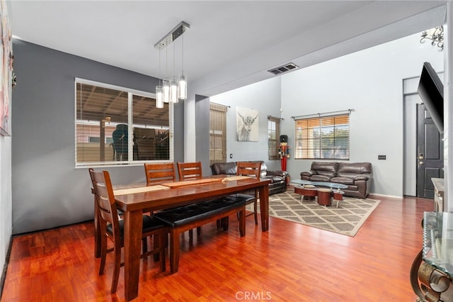 7459 Melanie Ct, Highland, CA 92346 - dining area featuring wood finished floors and a chandelier