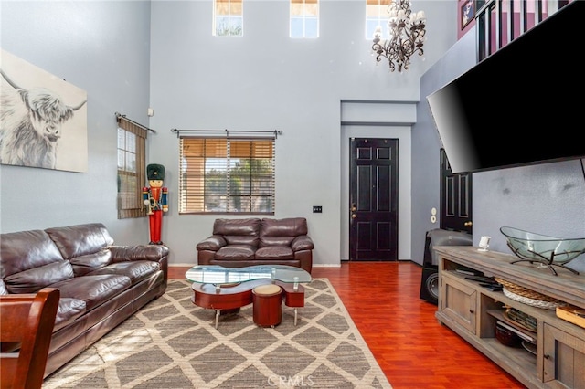 7459 Melanie Ct, Highland, CA 92346 - living room featuring a high ceiling, plenty of natural light, wood finished floors, and a chandelier