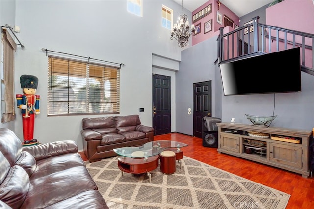 7459 Melanie Ct, Highland, CA 92346 - living room featuring a chandelier, healthy amount of natural light, wood finished floors, and a towering ceiling