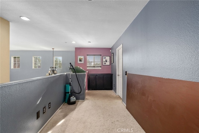 7459 Melanie Ct, Highland, CA 92346 - hall featuring light colored carpet, a textured wall, and recessed lighting