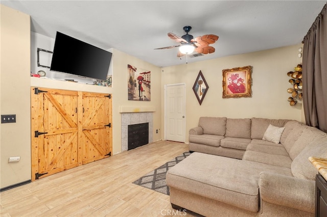 7459 Melanie Ct, Highland, CA 92346 - living area with ceiling fan, wood finished floors, and a tiled fireplace
