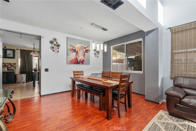 7459 Melanie Ct, Highland, CA 92346 - dining space featuring wood finished floors and a chandelier