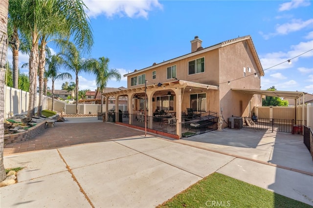 7459 Melanie Ct, Highland, CA 92346 - back of house featuring a fenced backyard, stucco siding, a patio, a chimney, and a gate