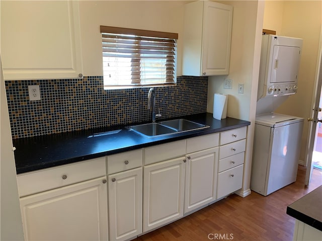 583 S Calle, Abronia, Palm Springs, CA 92264 - kitchen with dark countertops, light wood finished floors, and white cabinetry