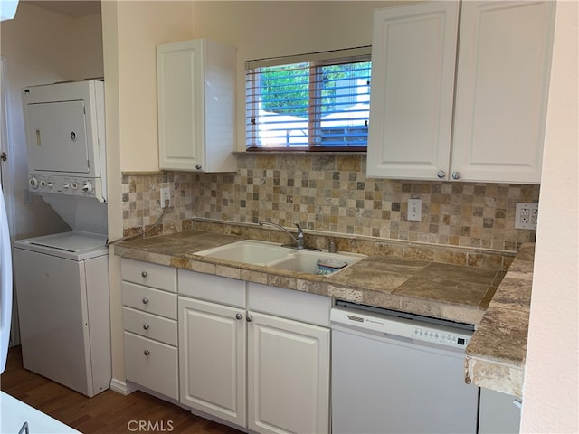 583 S Calle, Abronia, Palm Springs, CA 92264 - kitchen with dishwasher, stacked washer / drying machine, white cabinetry, and backsplash