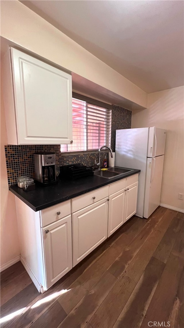583 S Calle, Abronia, Palm Springs, CA 92264 - kitchen with dark wood-type flooring, freestanding refrigerator, and white cabinets