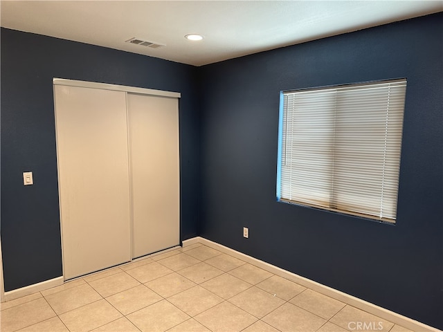 23610 David Ln, Moreno Valley, CA 92557 - unfurnished bedroom featuring a closet, recessed lighting, and light tile patterned floors