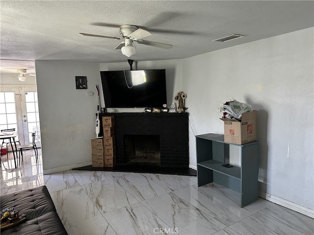 23610 David Ln, Moreno Valley, CA 92557 - living room with ceiling fan, marble finish flooring, a textured ceiling, and a brick fireplace