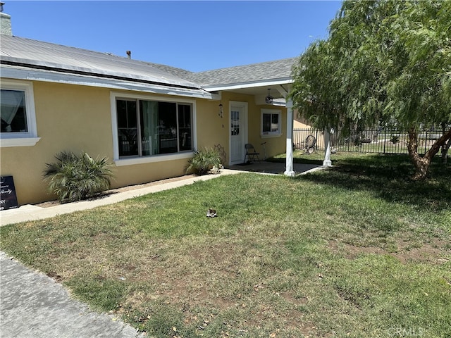 23610 David Ln, Moreno Valley, CA 92557 - view of front of home with stucco siding, solar panels, and a patio area