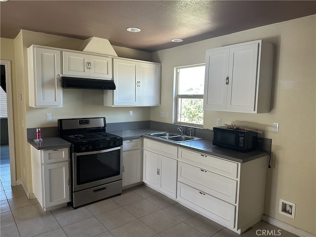 23610 David Ln, Moreno Valley, CA 92557 - kitchen featuring stainless steel range with gas stovetop, under cabinet range hood, black microwave, white cabinetry, and a textured ceiling