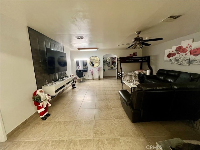 729 W Holt Blvd, Ontario, CA 91762 - living area featuring light tile patterned flooring, arched walkways, and a ceiling fan