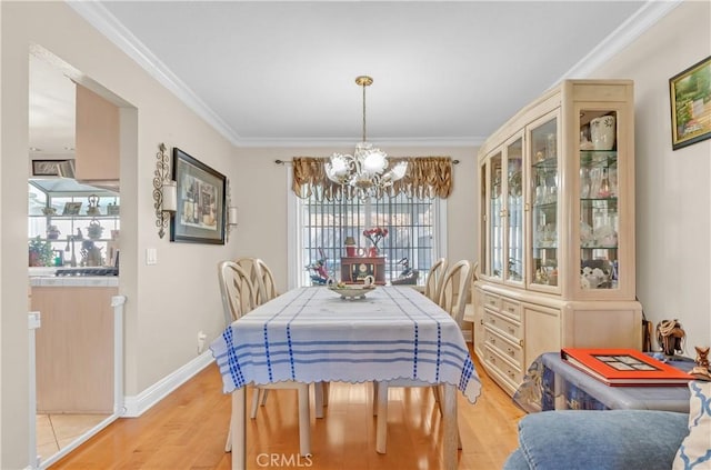 1010 W Yorktown Ave, Montebello, CA 90640 - dining space featuring a chandelier, light wood-style floors, and ornamental molding