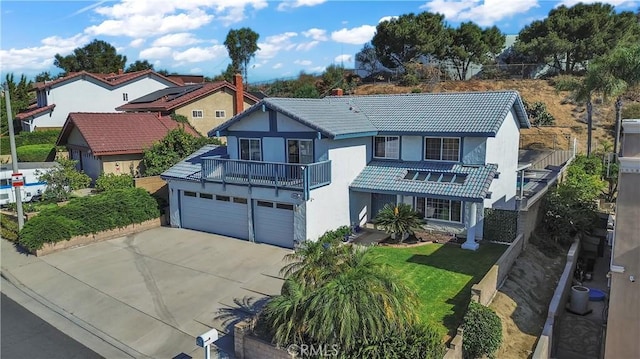 1010 W Yorktown Ave, Montebello, CA 90640 - view of front of house with driveway, a balcony, stucco siding, and a tiled roof