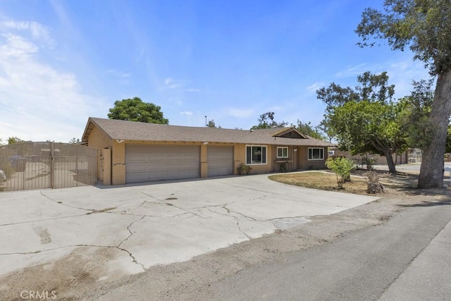 5956 Marlatt St, Jurupa Valley, CA 91752 - ranch-style house with an attached garage, driveway, and stucco siding