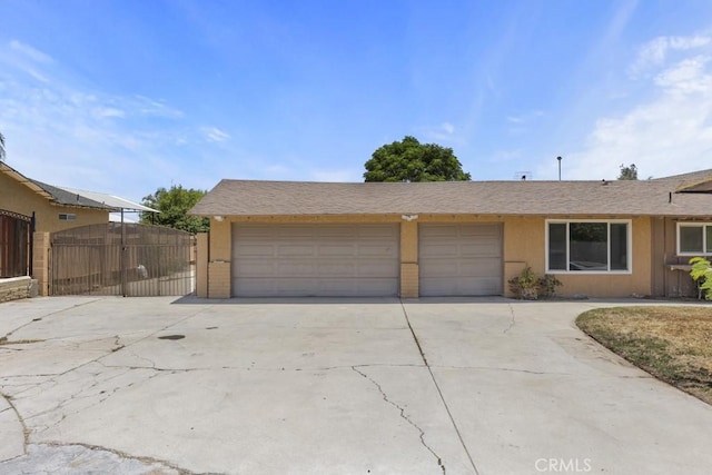 5956 Marlatt St, Jurupa Valley, CA 91752 - view of front of property with driveway, a gate, stucco siding, and a garage