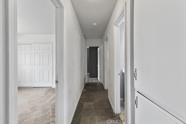 5956 Marlatt St, Jurupa Valley, CA 91752 - hallway featuring baseboards and dark stone finish flooring
