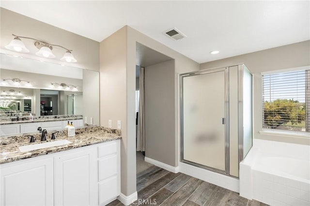 33883 Vinca Ln, Murrieta, CA 92563 - bathroom featuring a stall shower, vanity, a garden tub, and wood finished floors