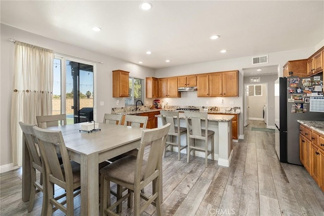33883 Vinca Ln, Murrieta, CA 92563 - dining room with light wood-style floors and recessed lighting