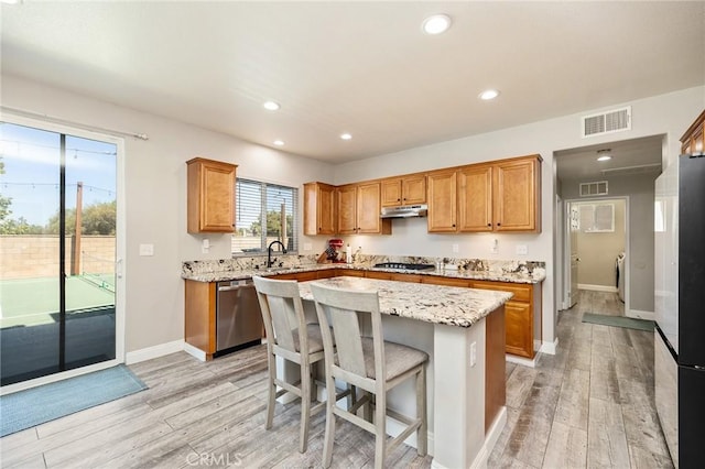 33883 Vinca Ln, Murrieta, CA 92563 - kitchen with stainless steel appliances, light wood finished floors, brown cabinetry, and recessed lighting