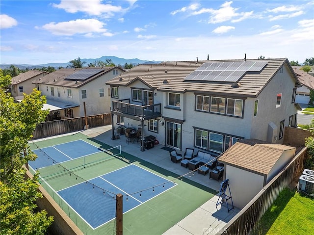 33883 Vinca Ln, Murrieta, CA 92563 - rear view of property featuring a fenced backyard, a mountain view, roof mounted solar panels, and a balcony