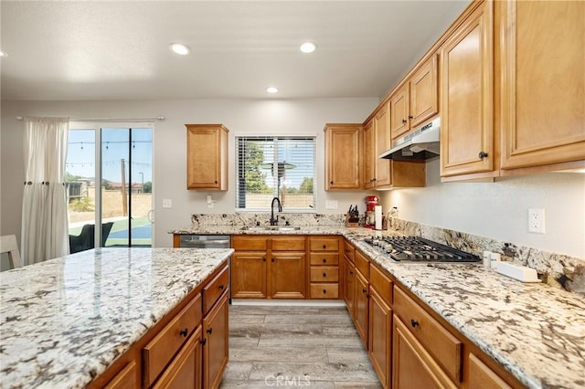33883 Vinca Ln, Murrieta, CA 92563 - kitchen featuring under cabinet range hood, stainless steel gas stovetop, light wood finished floors, light stone counters, and recessed lighting
